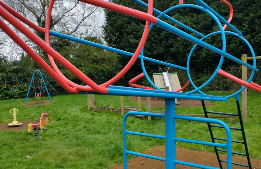 Blue and red climbing frame in the style of a rocket
