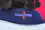 Multicoloured Cross of St Georges on the neck of an England football shirt